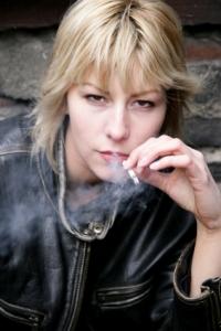 Tough teen girl smoking a cigarette