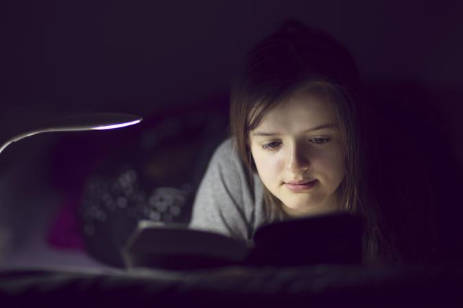 Teenage girl reading book