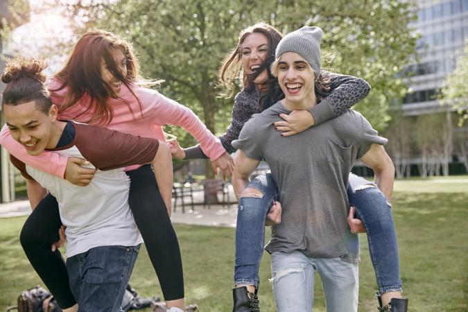 Teen couples racing piggyback