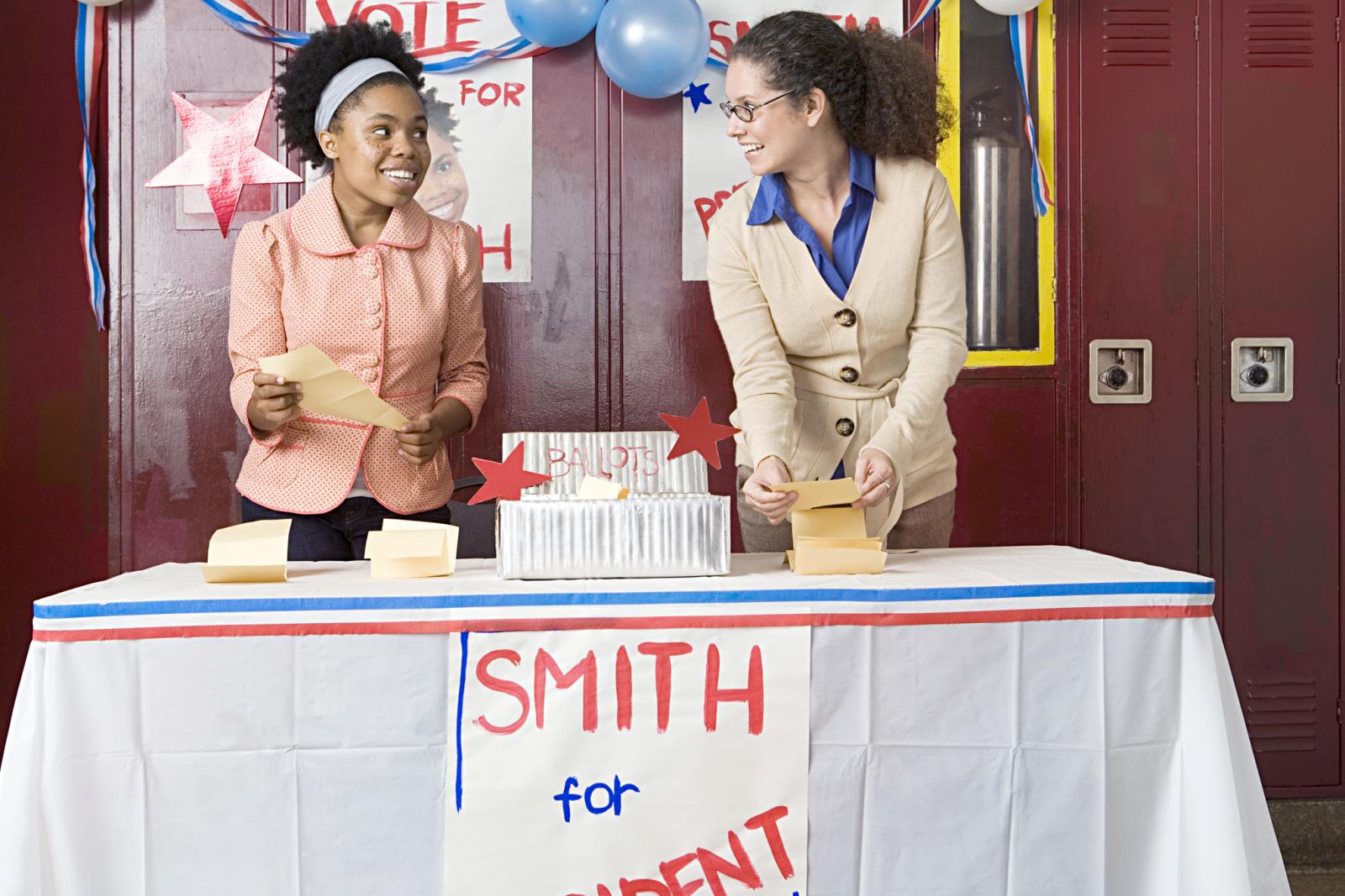 Girl and teacher counting votes