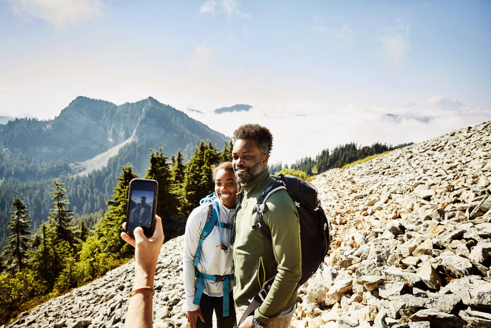 father and daughter hiking in mountains