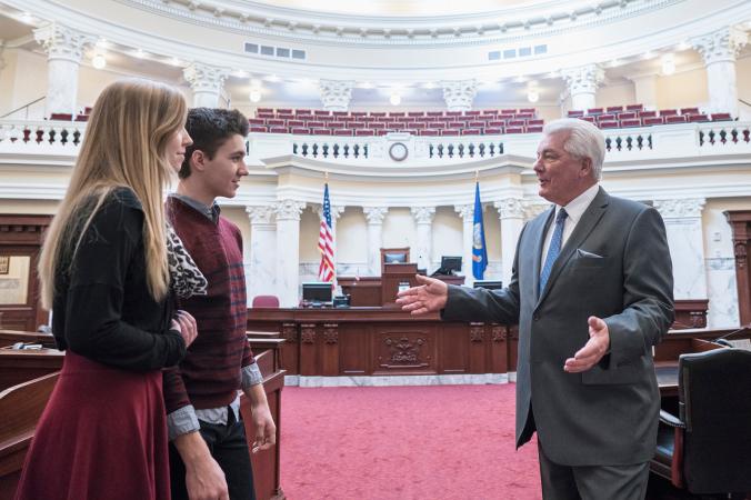 teens talking with politician