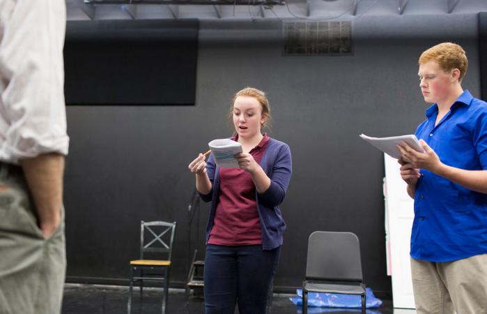 Teens reading scripts in front of a few casting agents