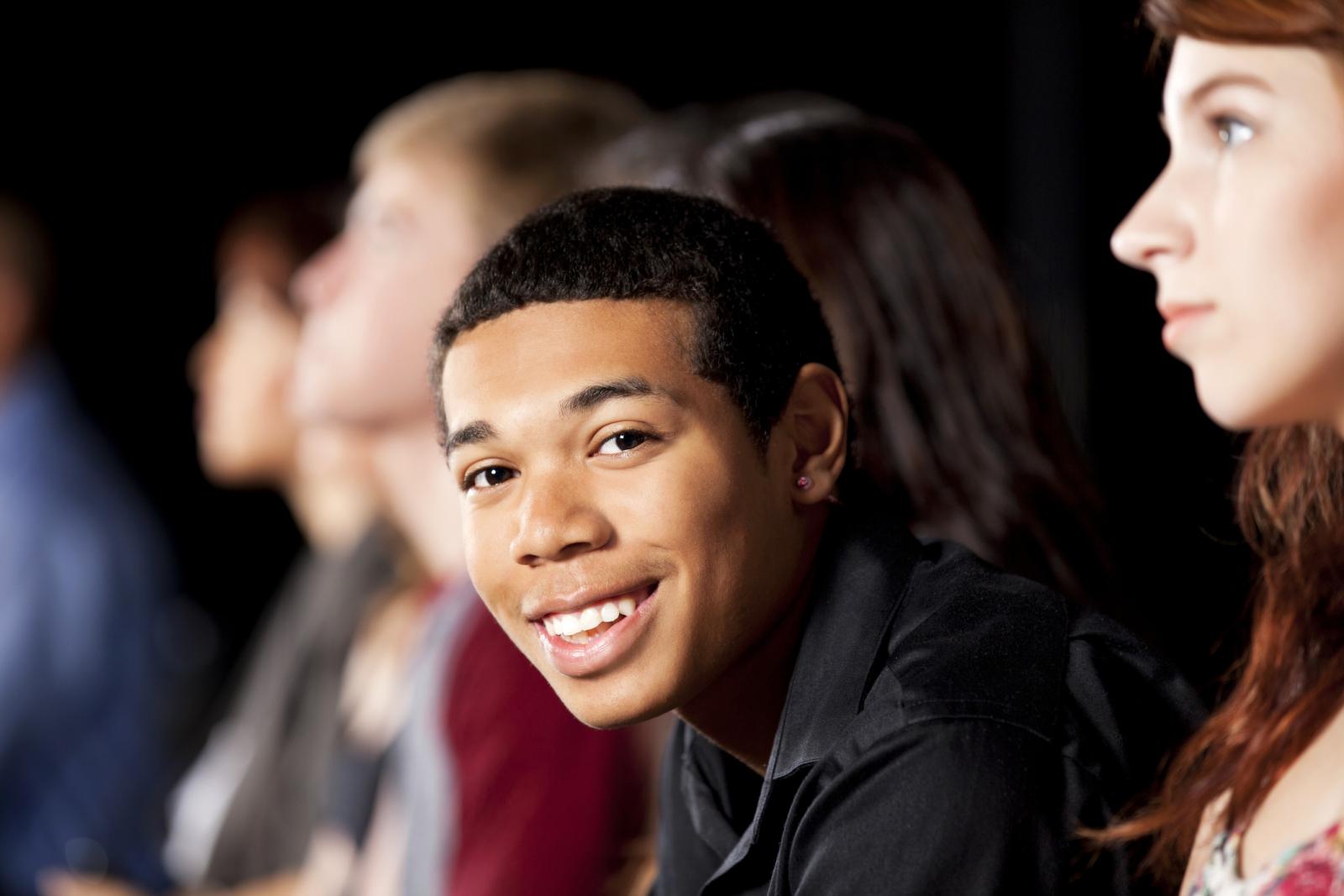 Happy teenager among his peers