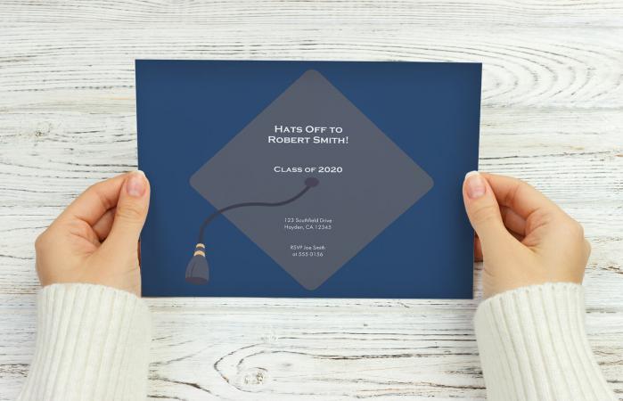 female hands hold graduation invitation