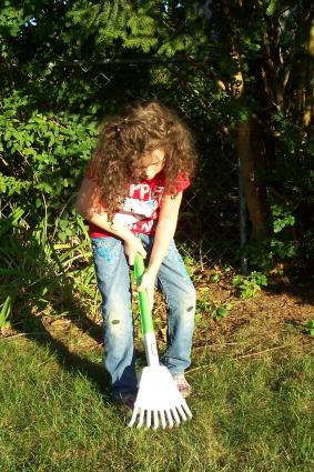 Child gardening with Little Tikes Rake