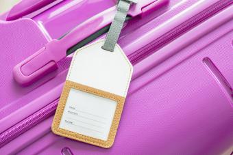 Luggage tag on pink suitcase