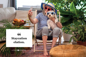 Woman with dog relaxing and taking selfie indoors at home