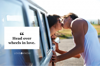 Young girl leaning out her car to give her boyfriend a kiss