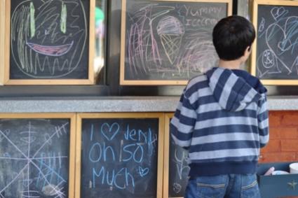 kid on chalkboard