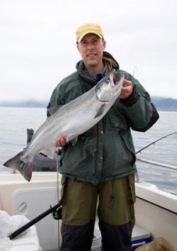 Fisherman with silver salmon in Alaska