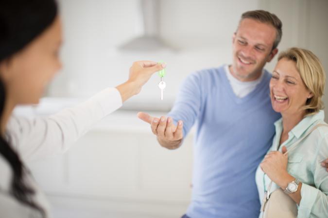 Realtor giving couple keys to home