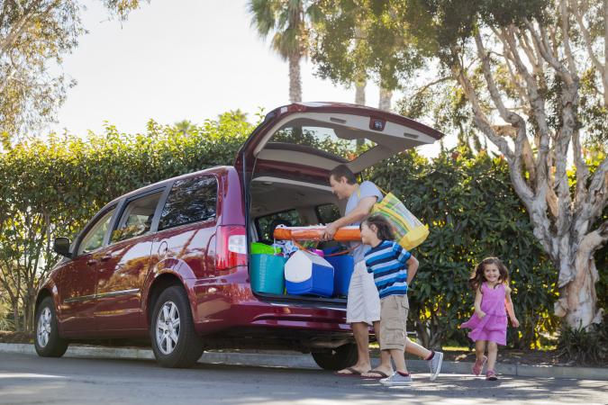 Family packing minivan before vacation