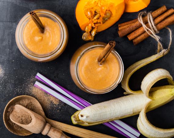 pumpkin spice smoothie surrounded by ingredients