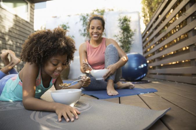 mother and daughter eating cereal