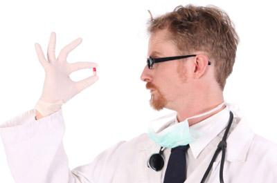 Doctor inspecting B12 capsule