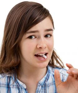 child taking vitamin
