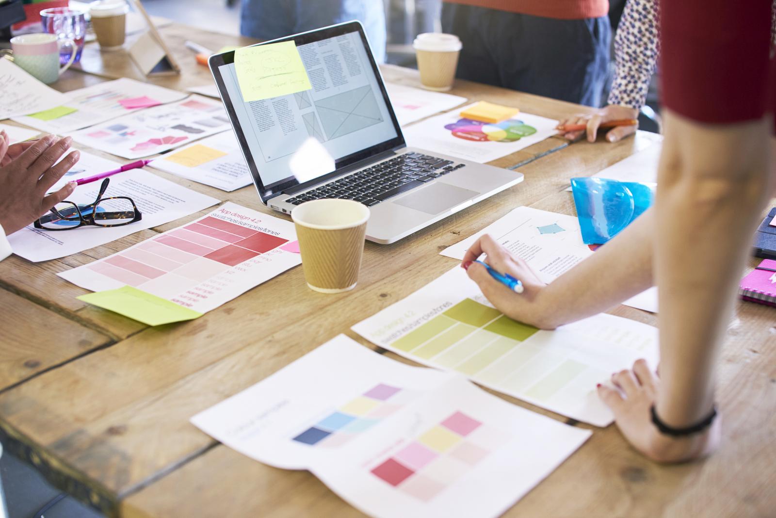 Designers Discussing Layouts And Color Schemes