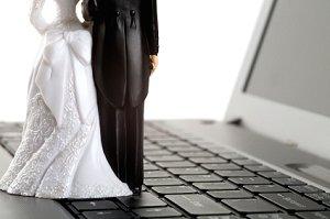 Bride and groom figurines on a laptop