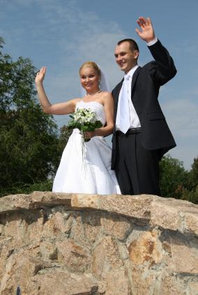 Bride and groom wave goodbye