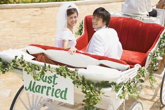 Bride and groom in horse drawn carriage