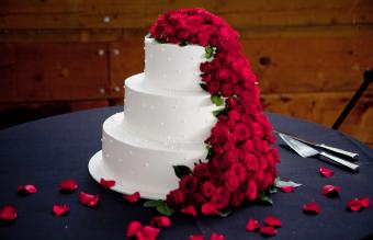 white wedding cake with red roses