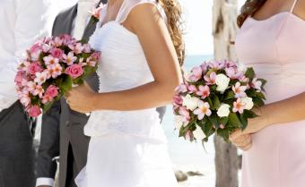 Bride and Bridesmaid holding beautiful frangipani bouquets