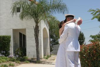 Bride and military groom kissing