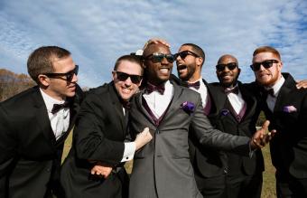 Groom and groomsmen posing for wedding pictures