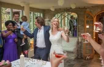 newlyweds toasting at reception