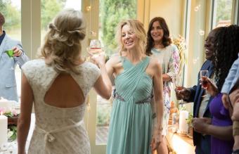 Wedding guests toasting to newlyweds