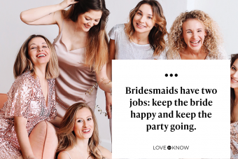 A group of bridesmaids in festive dresses drinking champagne