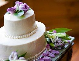 An elegant wedding cake with beads and lavender roses