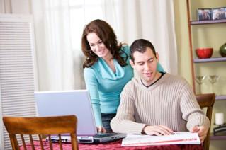 Couple working on a wedding guest list worksheet