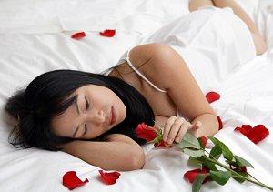 Bride on a bed strewn with rose petals