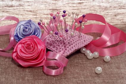 Pin cushion and ribbons for making satin roses
