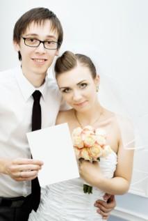 bride and groom holding card