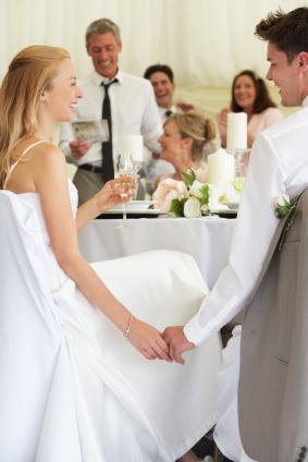 couple laughing at best man's speech