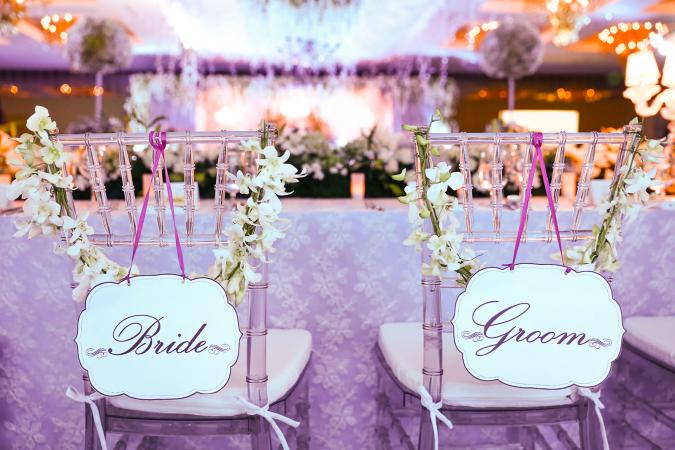 bride and groom seats at head table