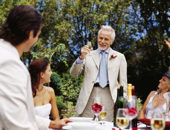Father toasting couple at wedding