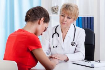 Doctor comforting distressed patient; © Katarzyna Bialasiewicz | Dreamstime.com