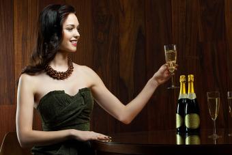 woman sitting at table with champagne