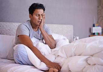 man sitting on bed