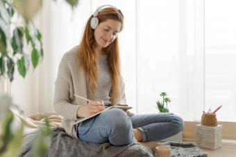 person writing in journal for stress relief during holidays