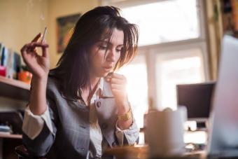 Woman coughing while smoking weed