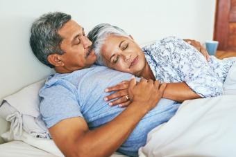 senior couple embracing in bed