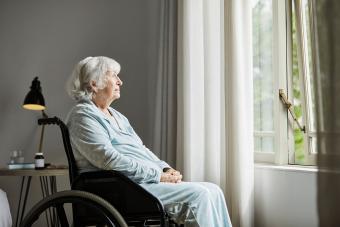 Contemplated senior female sitting on wheelchair