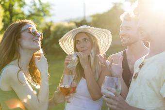 Four friends drinking and talking in the garden