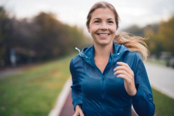 Woman jogging outdoors on cloudy day in autumn