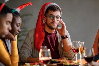 depressed and withdrawn man at holiday party with friends